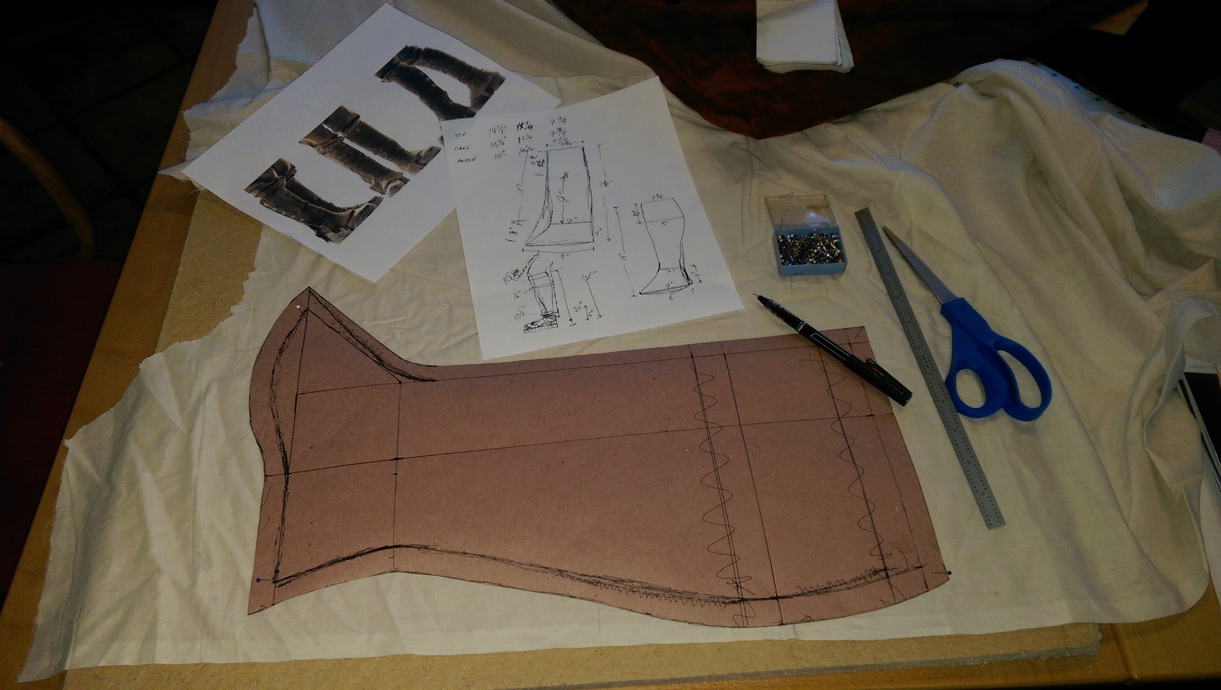Measurements and calculations drawn out on construction paper, then cut out and transferred to muslin for a prototype build.