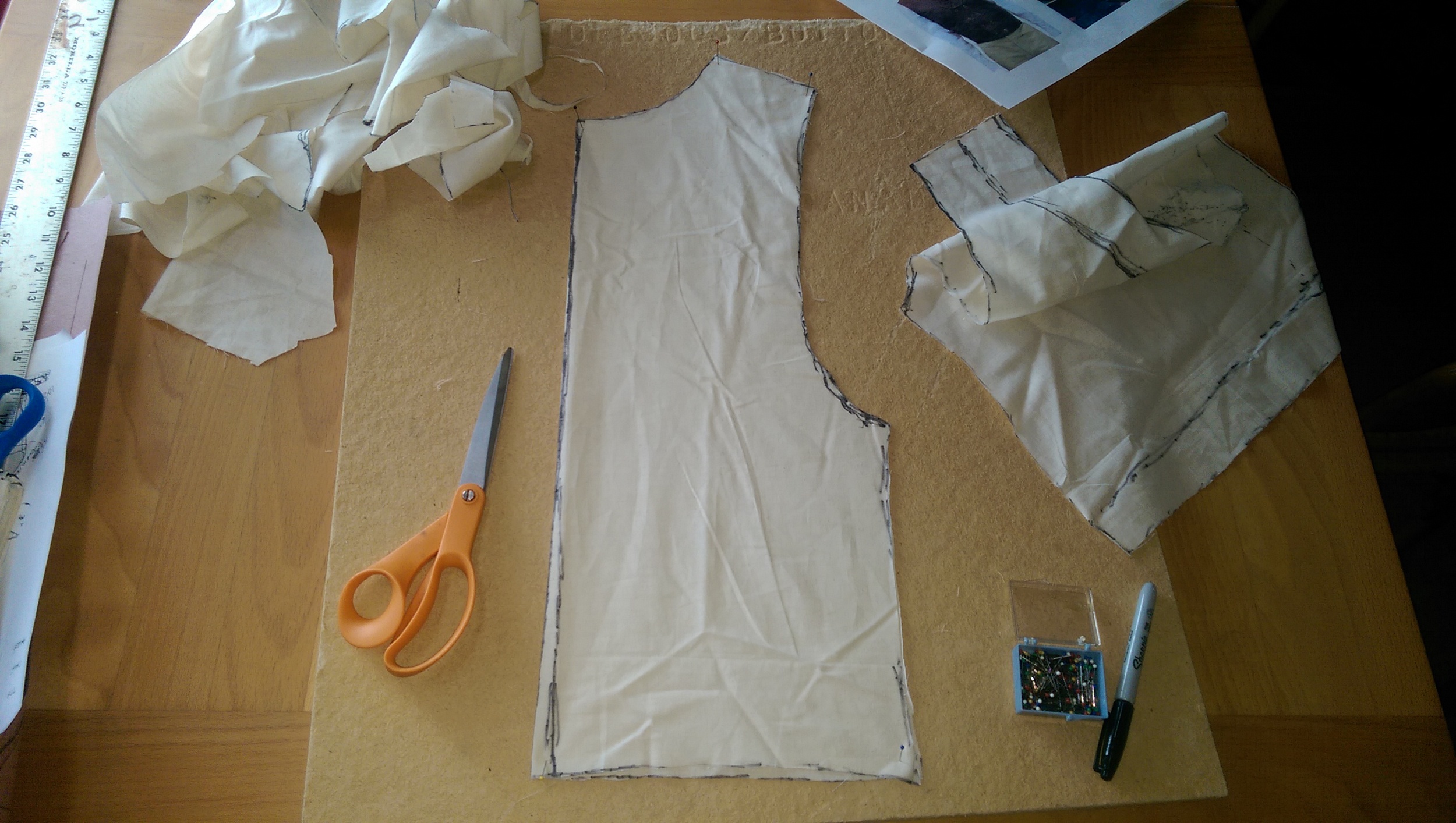 Cutting out the marked muslin pieces and trimming the back piece to be symetrical