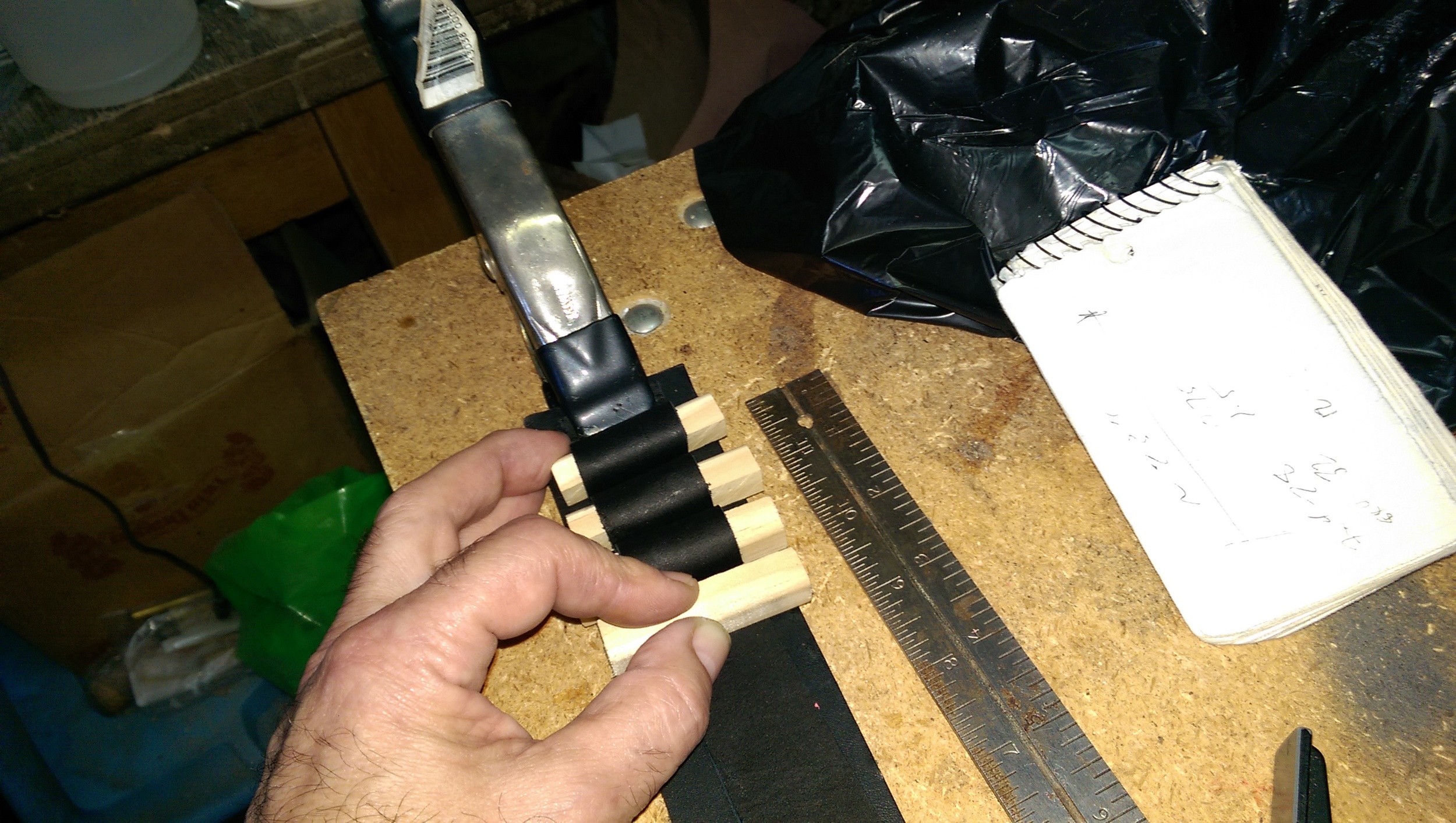 Using spacers to determine the spacing along the two leather straps (0.75" inches along the base and 1.5" for the pockets)