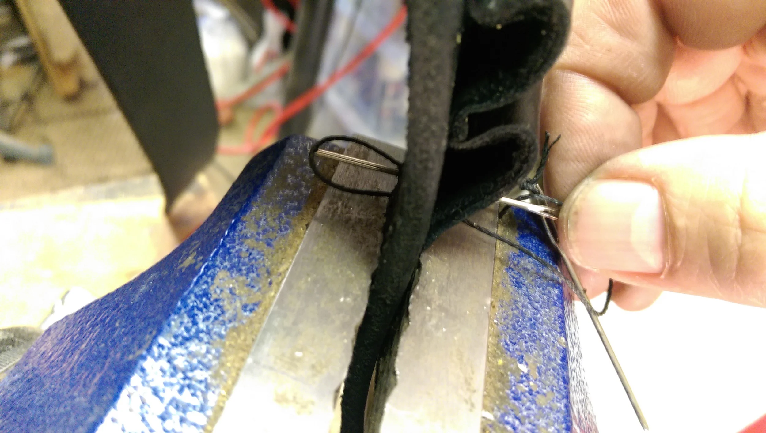The stitching needles are both pushed through new hole from opposite directions, forming the stitch.