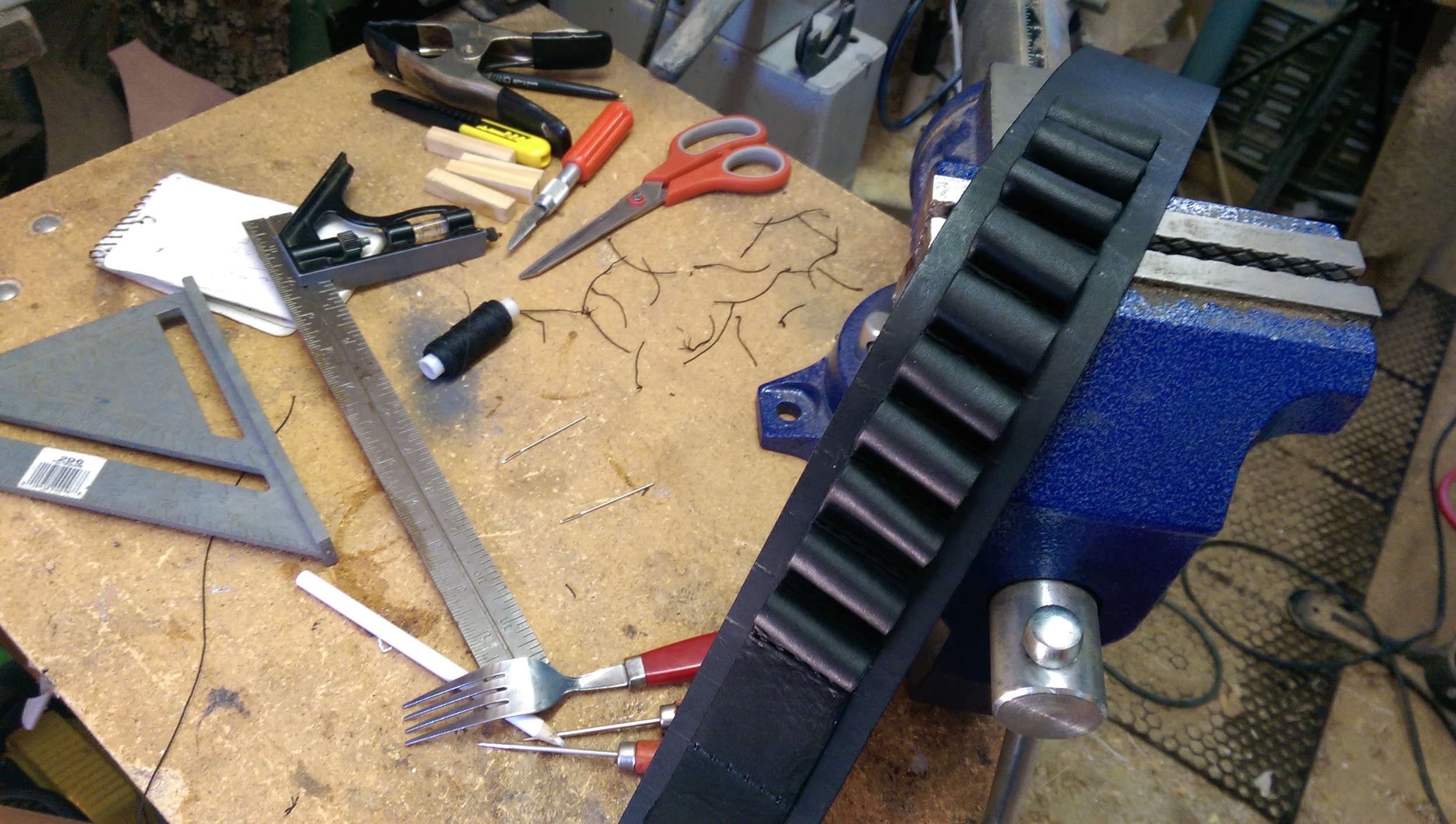 First strip of soft leather pockets stitched along the base strap. Two more soft leather strips are used for all of the pockets.