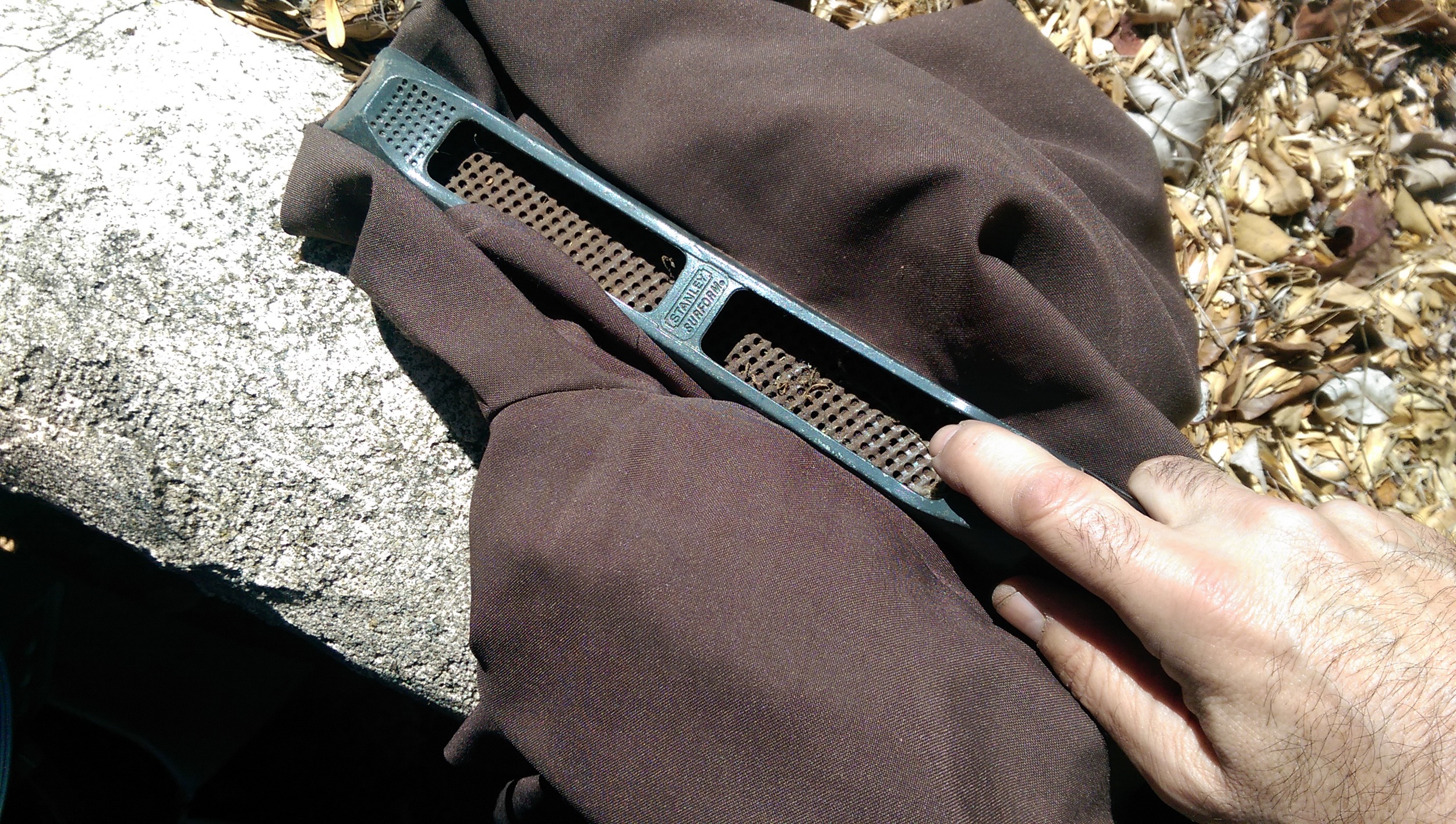 I was using a wood rasp on the polyester pants and only making minor wear marks