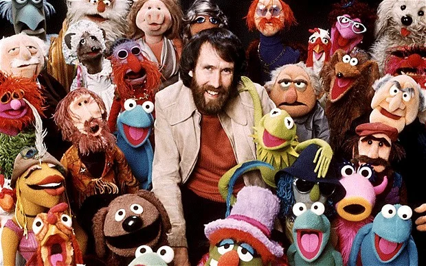 Jim Henson surrounded by the Muppets he created