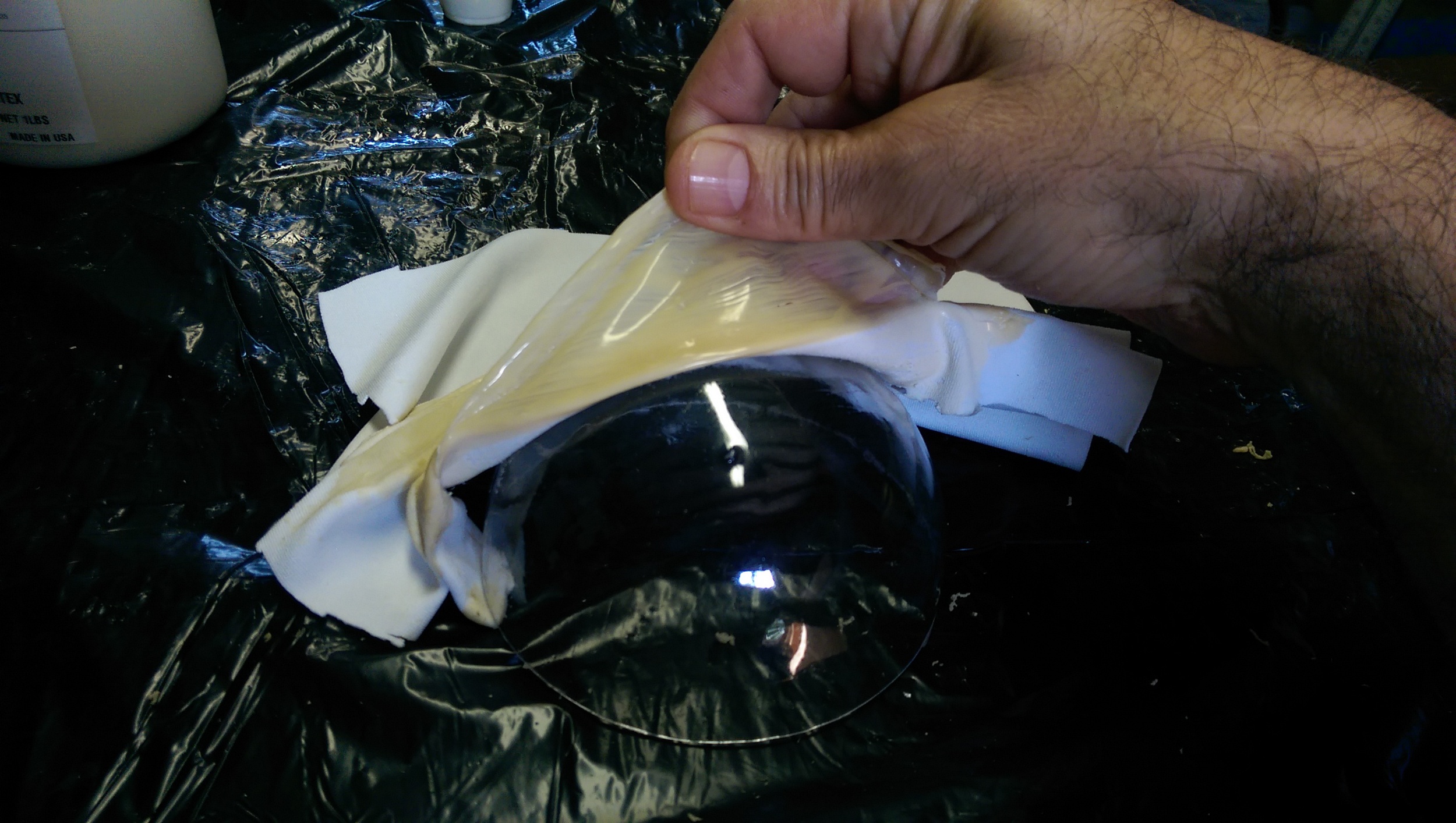 The silicone forms another layer over the spandex, smoothing the wrinkles and giving it a rubbery texture