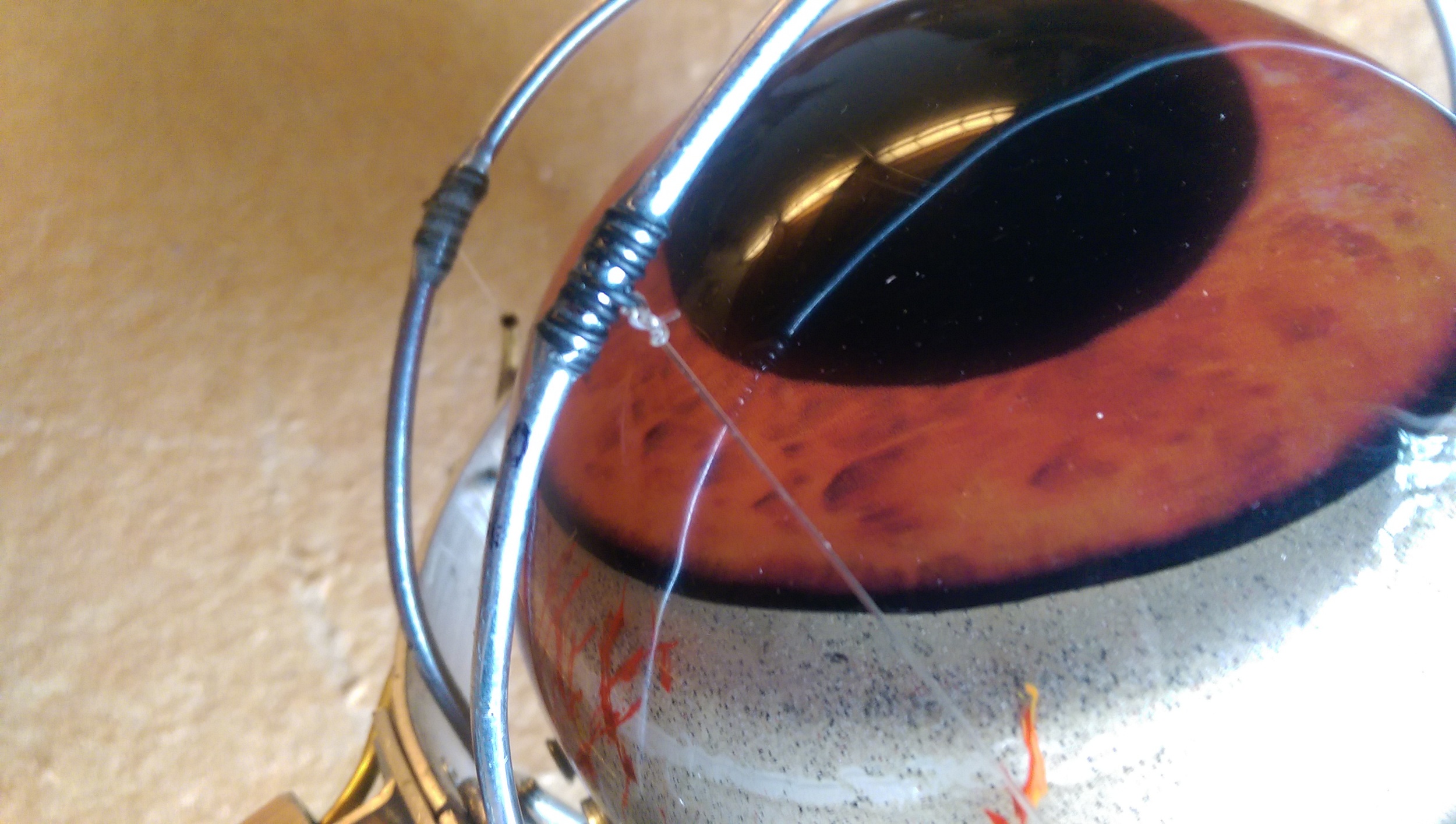 The attachment point epoxied to the eyelid lever and showing the monofilament knot