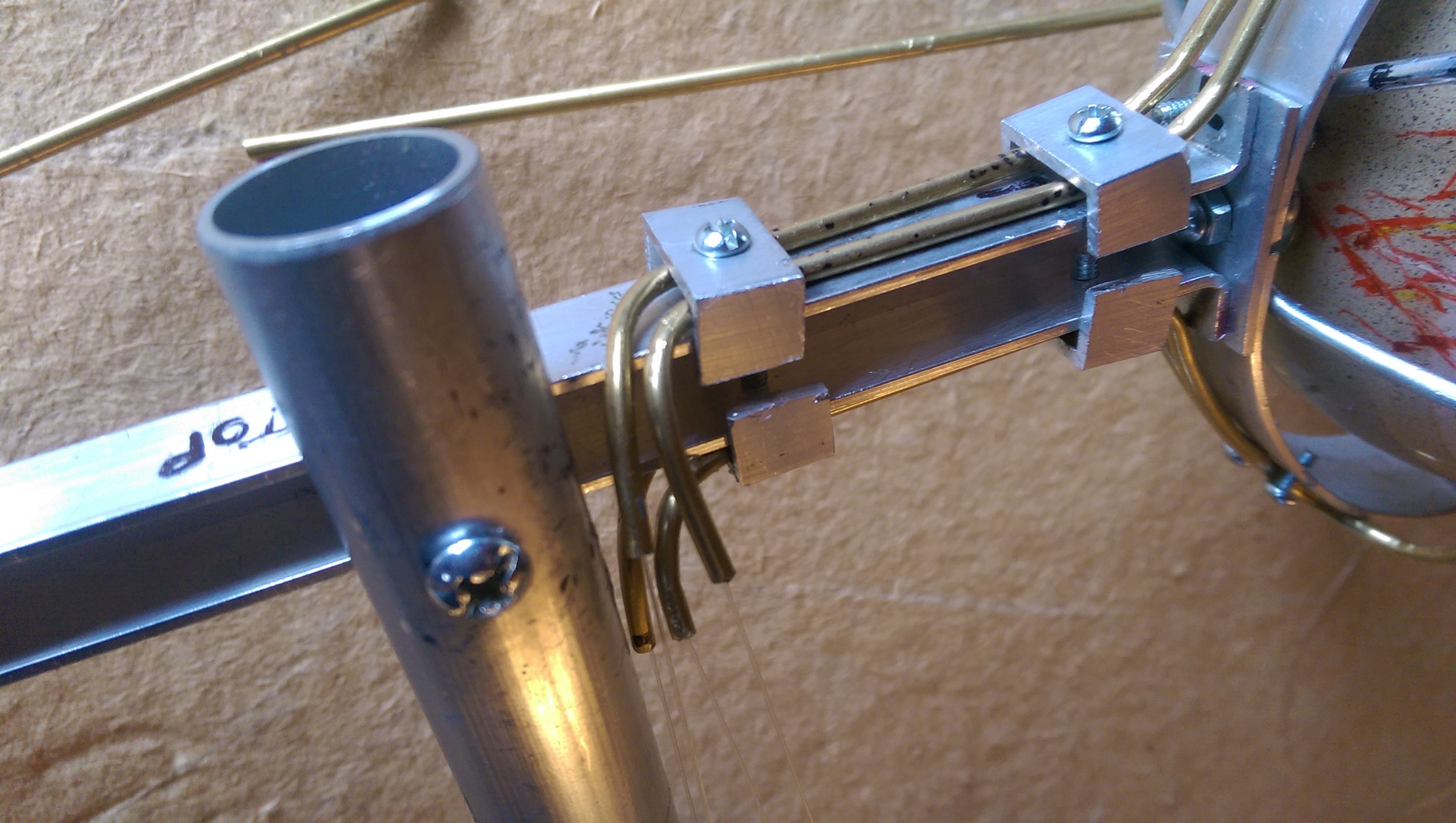All four tendons for one eye are routed down towards the solenoid rack