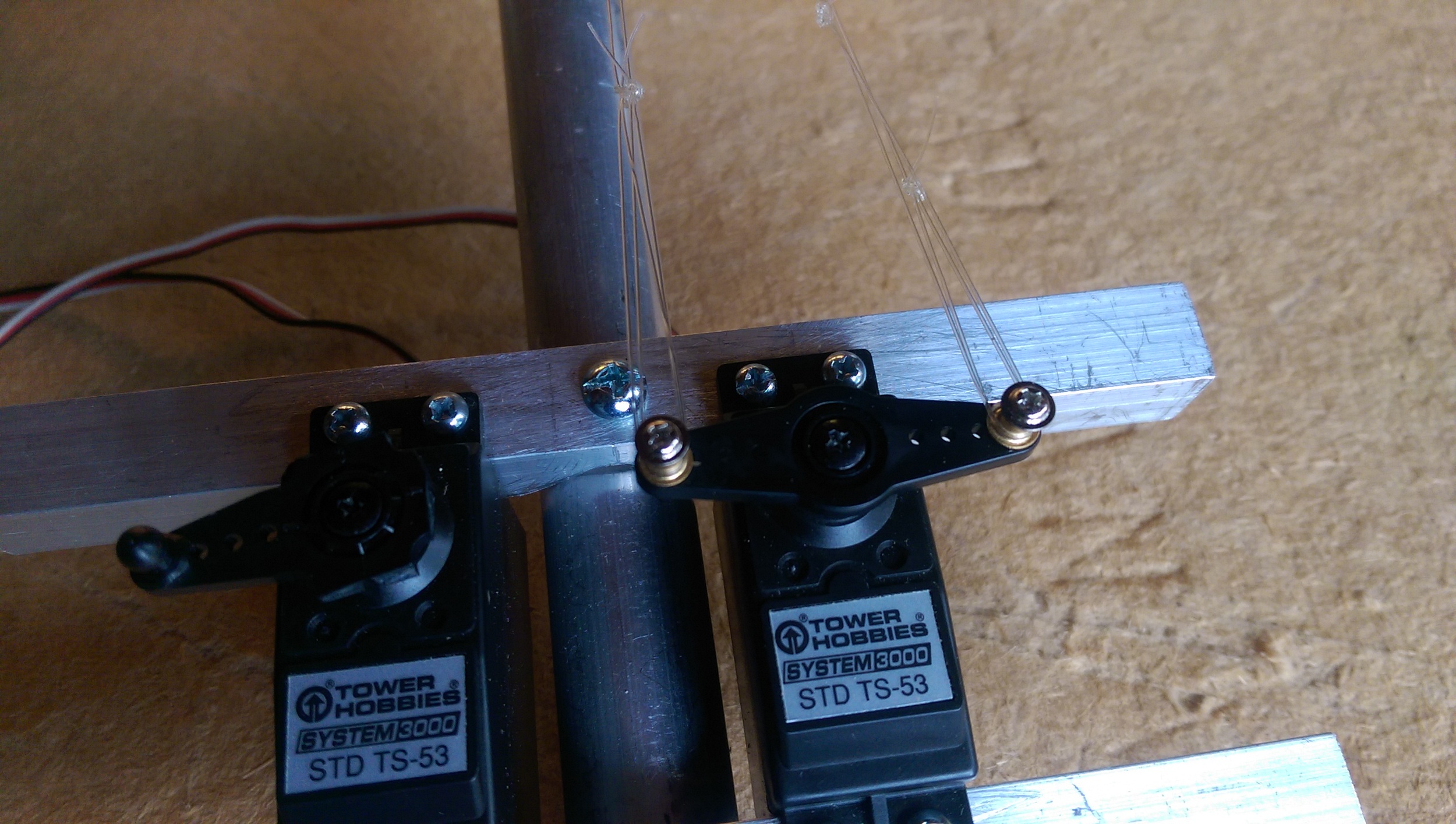 The four tendons each get a loop tied at the end and two are attached to each side of a solenoid arm