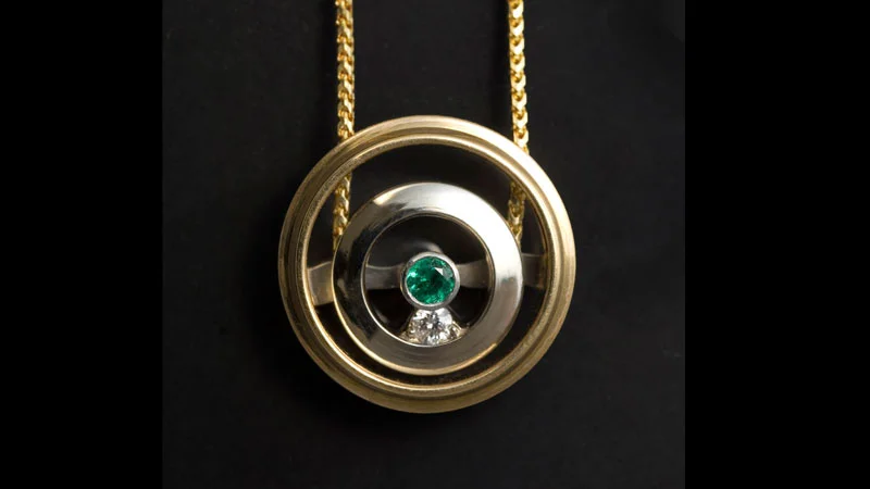 Circle Pulley. 18 karat white and yellow gold, cast, constructed and machined with emerald and diamond.