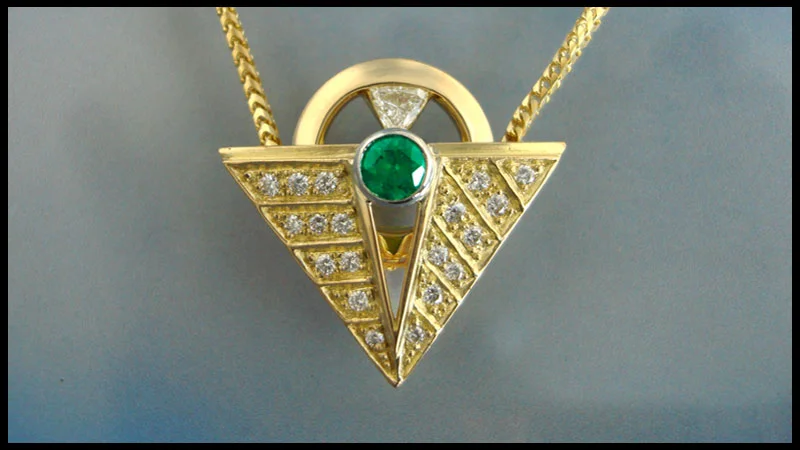 Cast, constructed and machined 18 karat yellow gold and platinum with emerald and diamonds. 