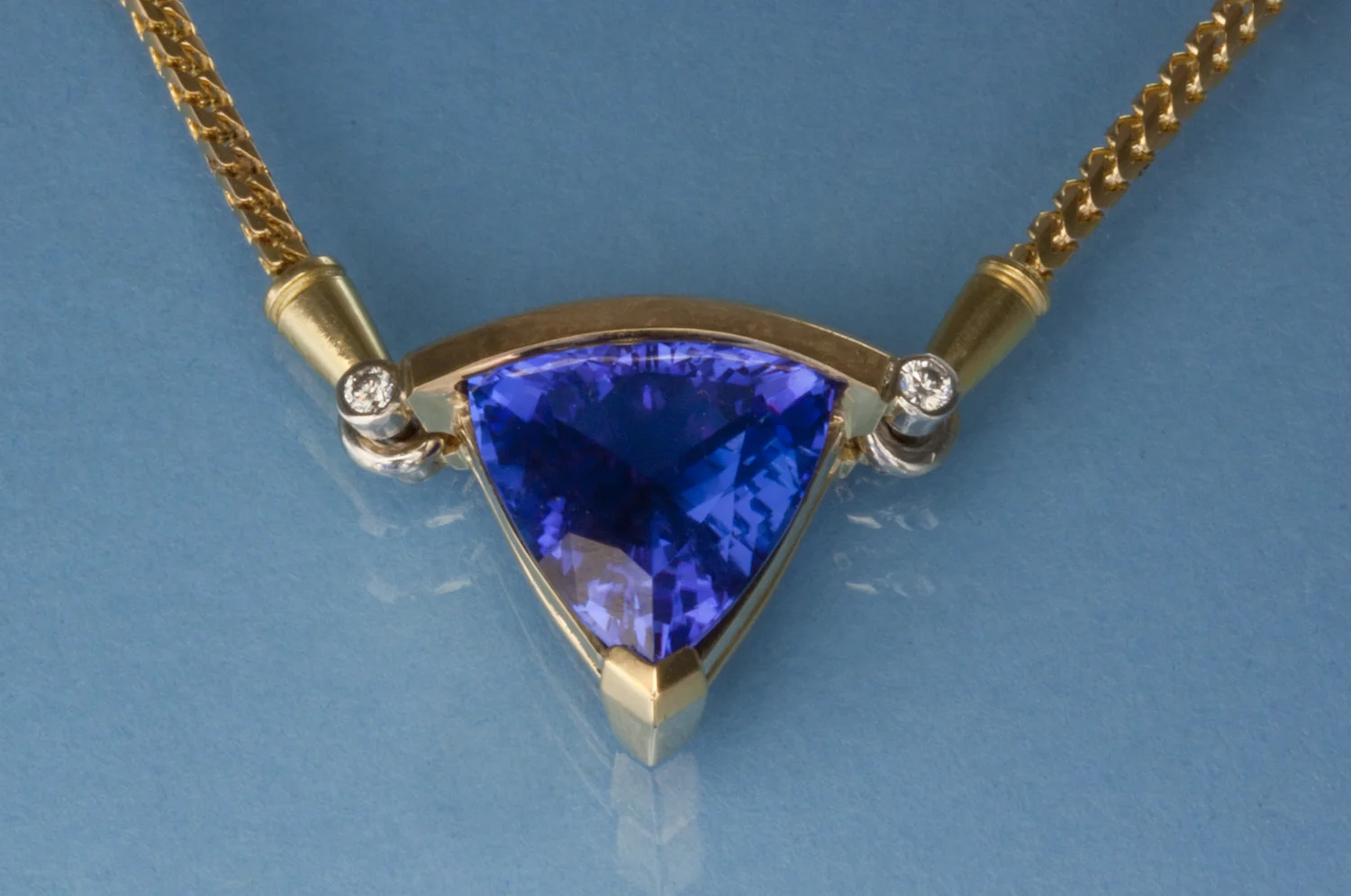 Superb trillion Tanzanite in 18 karat yellow gold, platinum and diamonds.