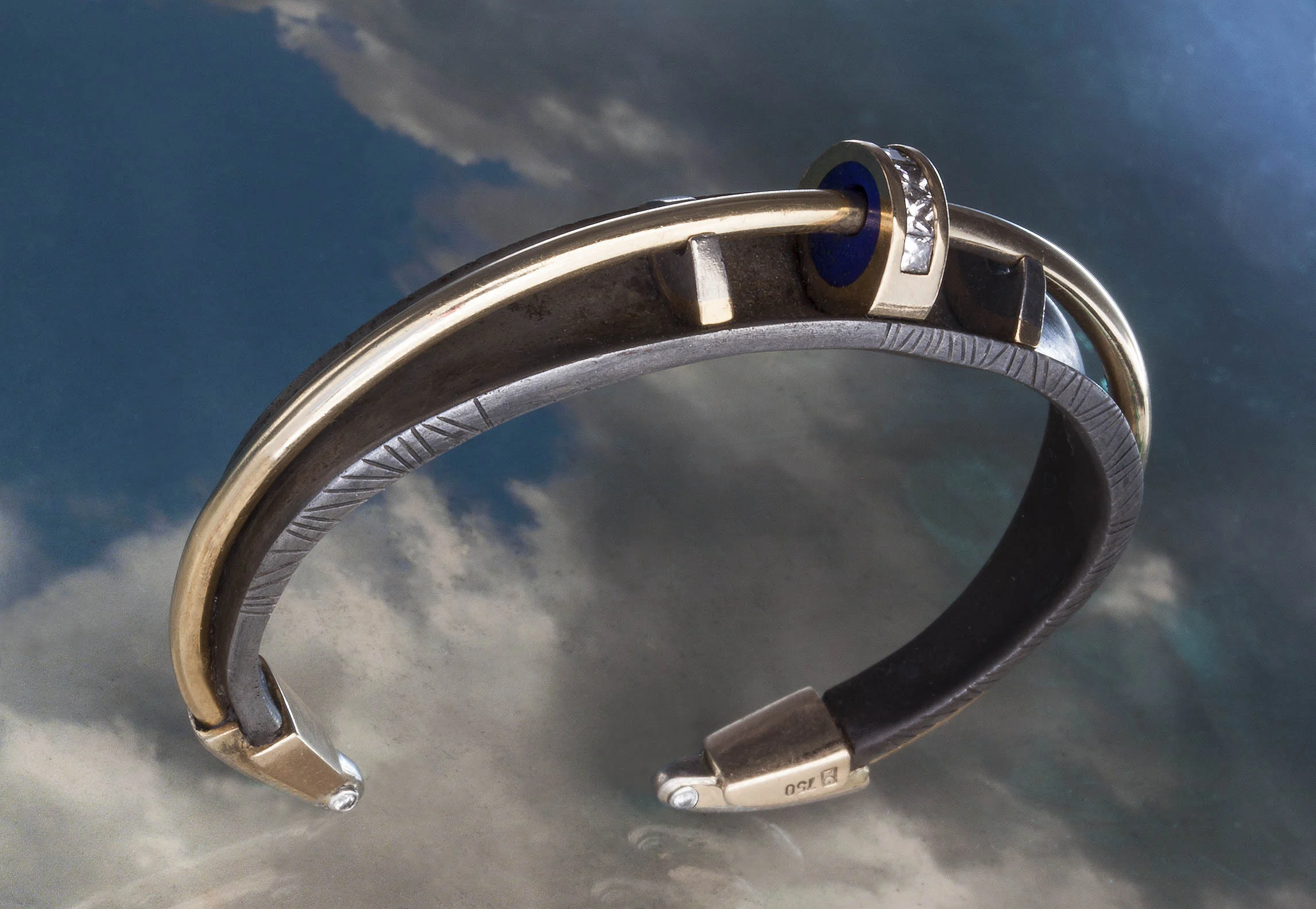 Forged steel bracelet with 18 karat yellow gold platinum and diamonds.
