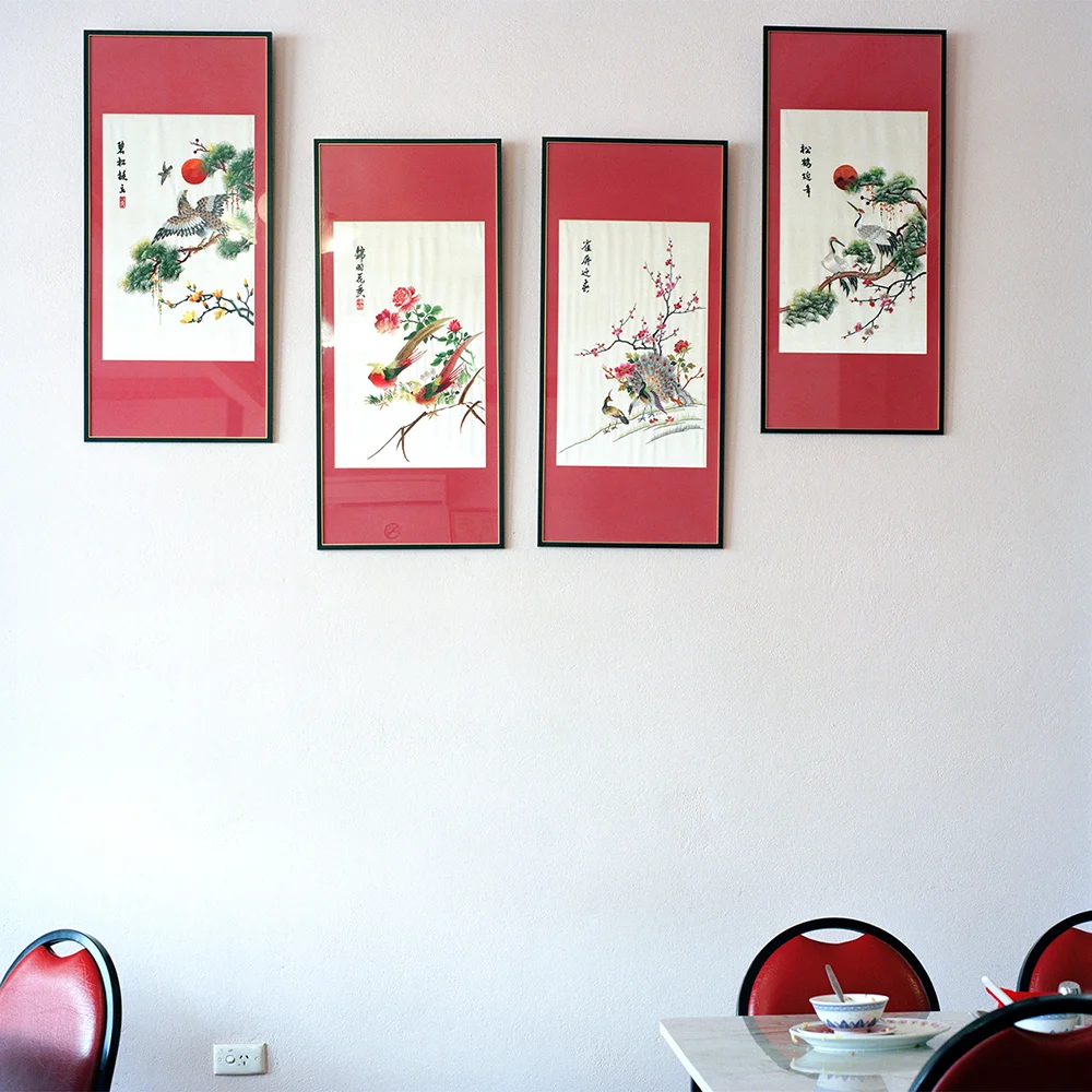Decades ago, the ubiquitous Asian restaurant in suburban Australia developed a reputation for being an exotic ‘family night out’. Since then, menus and cooking styles have been adapted to suit local tastes and local produce giving rise to the vernacular ‘chop suey’ cuisine. The photographs in this ongoing series, record just some of the unique décor, interiors, patrons and restaurateurs of these suburban diners, many of which are disappearing through re-development ventures. Integral to the story of suburban and regional Australia, they remain beacons of cultural and culinary comfort.
