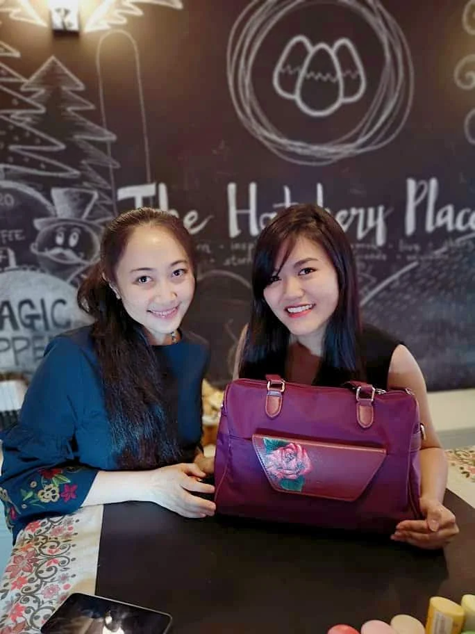 Elaine Wong & Nicole Chua with the painted bag