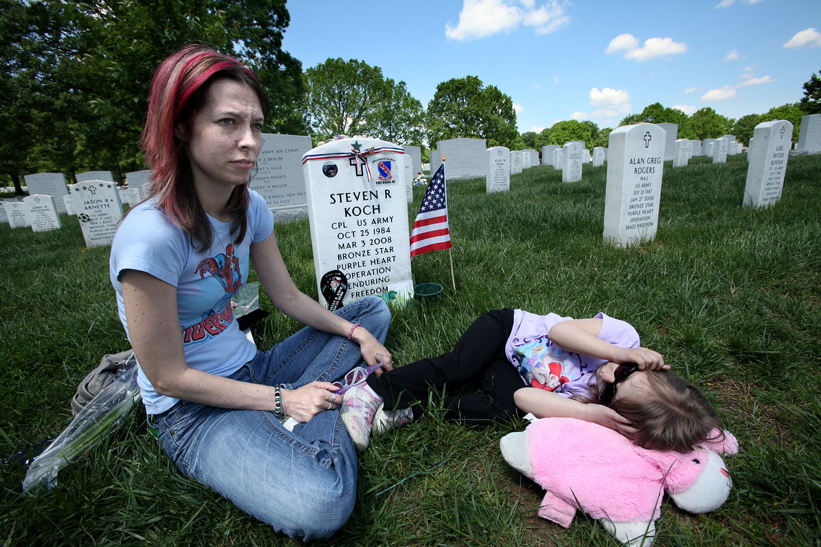 Amy is visiting her husband Steve's grave at Arlington National Cemetery. Their daughter Zoe is with her. He died in Afghanistan in 2008.