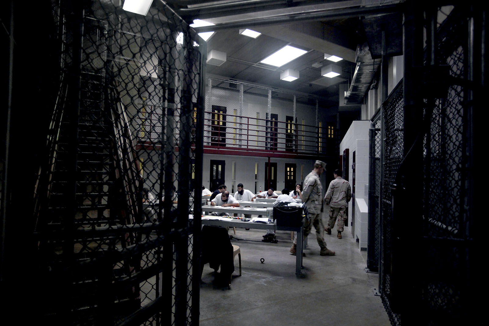 Prisoners at Guantanamo Bay are having a drawing class. 