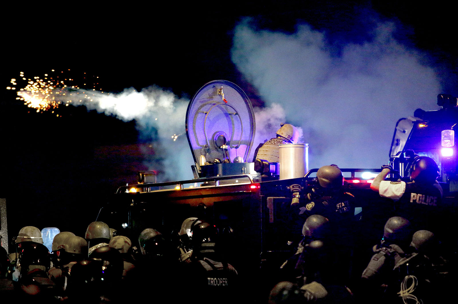 The police are firing tear gas at the protesters. 