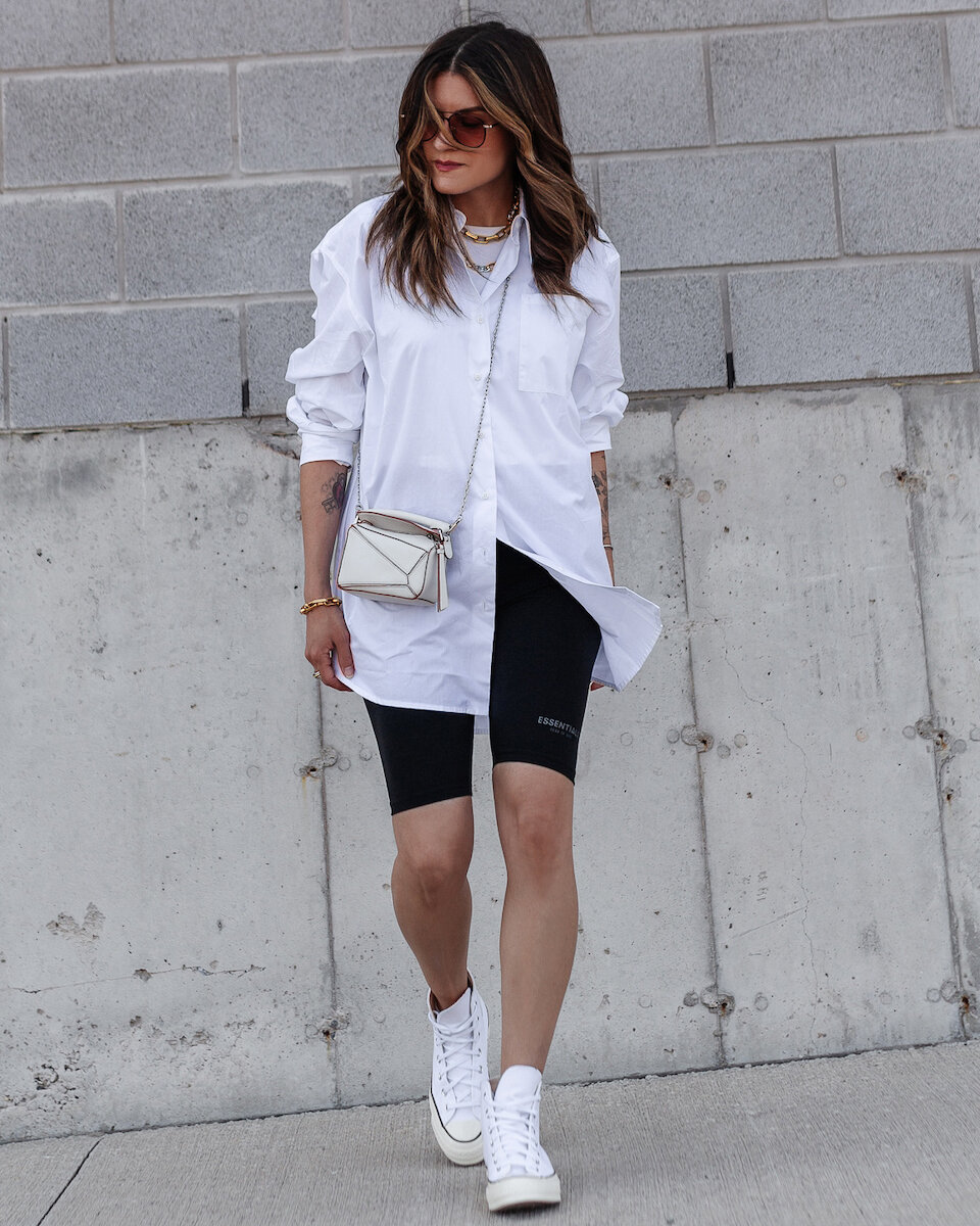 nathalie martin woahstyle.com, essentials fear of god bike shorts, oversized boyfriend button up shirt, converse chuck Taylor high tops sneakers, striped knit sweater, white loewe nano puzzle bag review outfit inspo streetstyle_2800.jpg