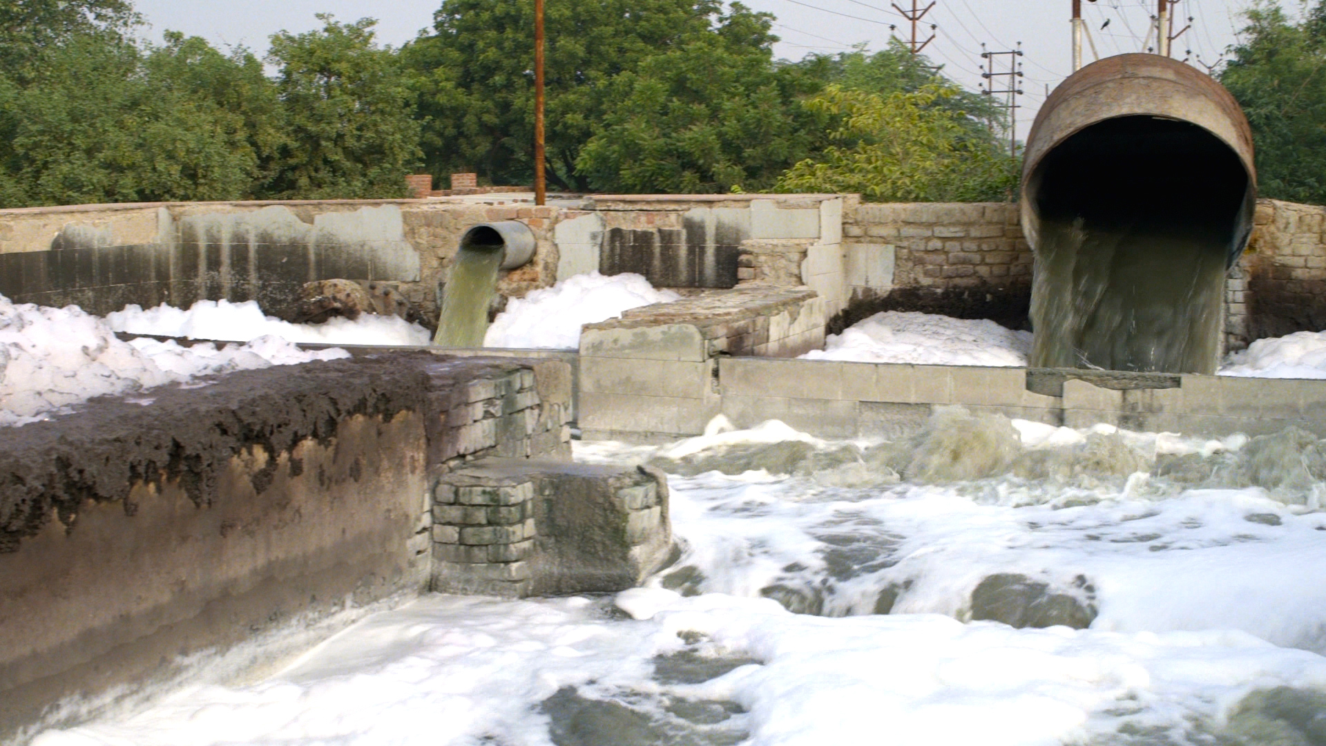 Chemical waste dumping into a flowing river next to a textile factory. Source: The True Cost