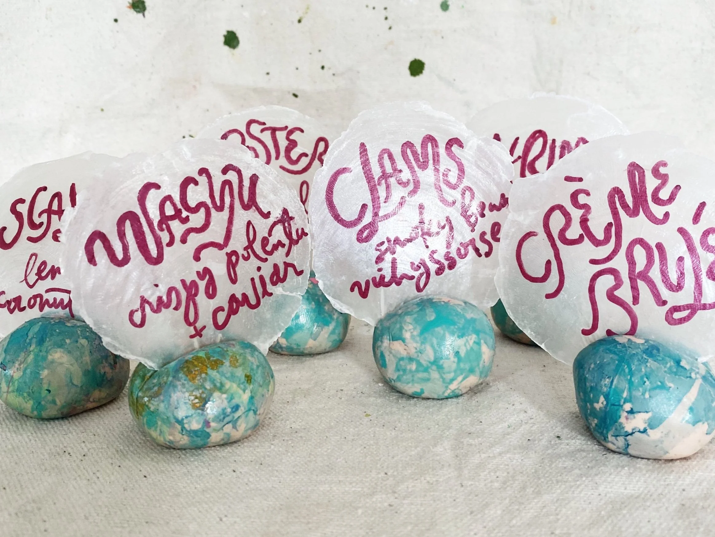 loose+fun+whimsical+style+of+hand+lettering+on+raw+capiz+shells+with+marbled+base.jpg