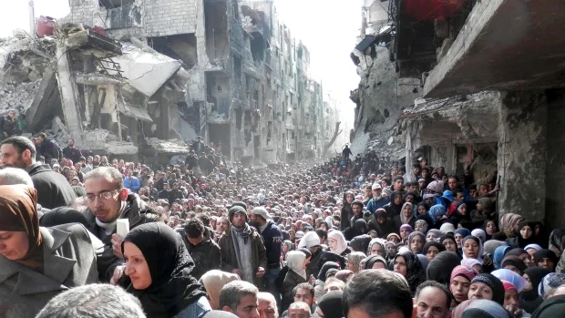 Photo taken in Damascus on January 31, 2014 of Syrians lining up for food and supplies. Released by the United Nations Relief and Works Agency.