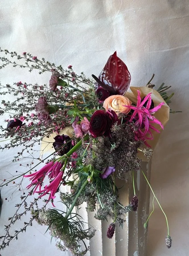 a large, hand-tied bundle for valentines day in a moody color palette