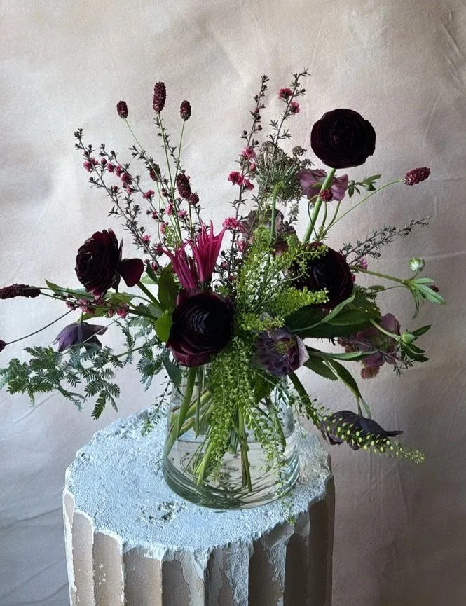 a medium-sized valentine centerpiece in a moody palette