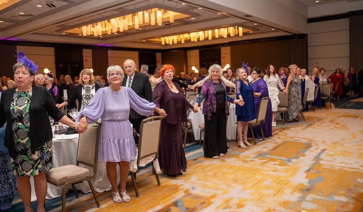 Mary Kaye Ernest at Paint the World Purple Gala singing of Let There Be Peace on Earth.jpg