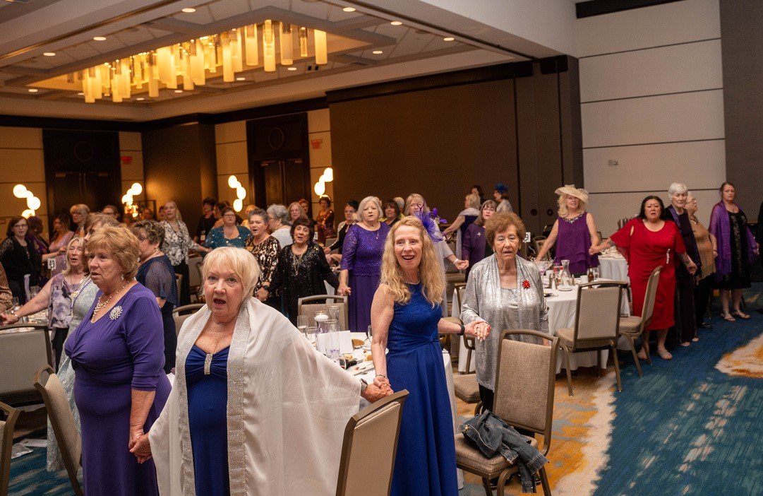 Sue Bessert at Paint the World Purple Gala singing of Let there be Peace on Earth.jpg
