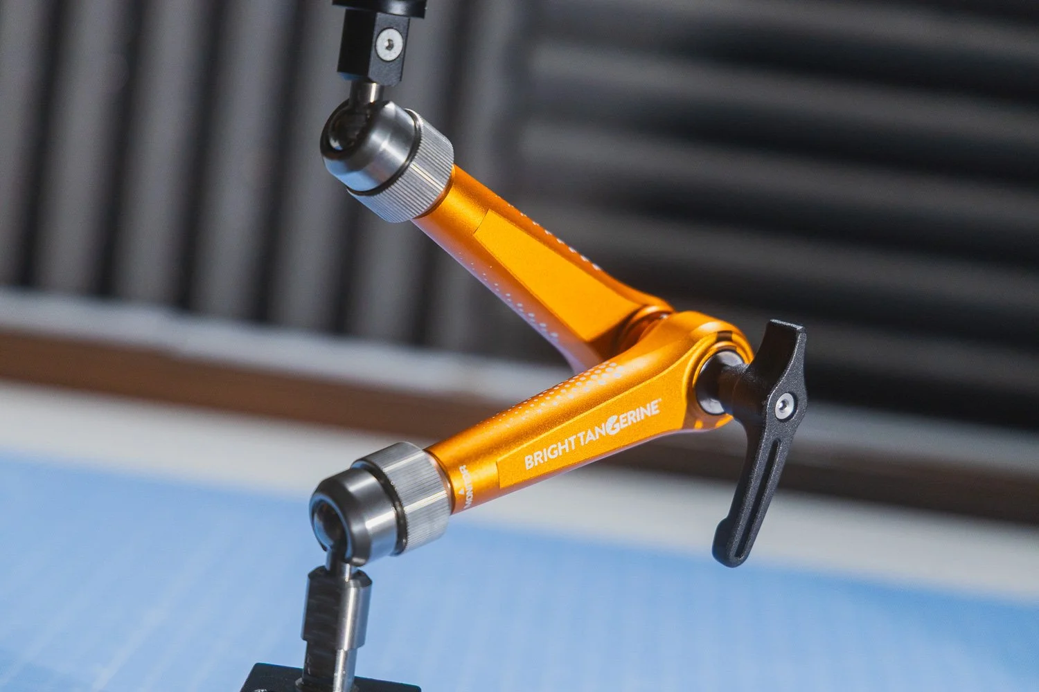 Bright Tangerine Titan Arm 2 Ti secured to desk