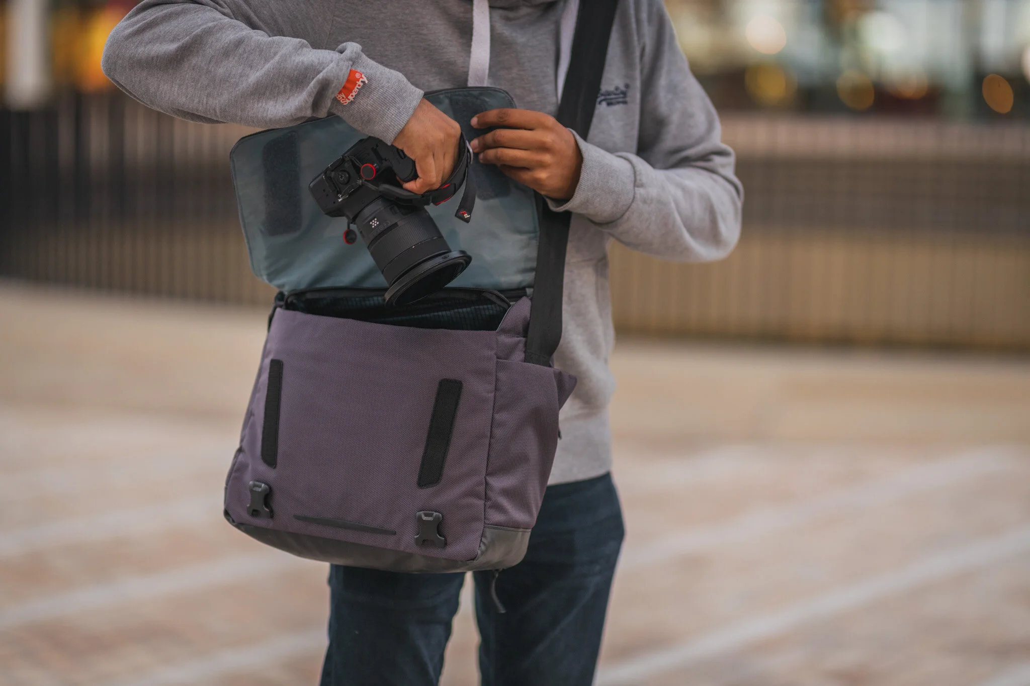 A person removing a camera from a camera bag