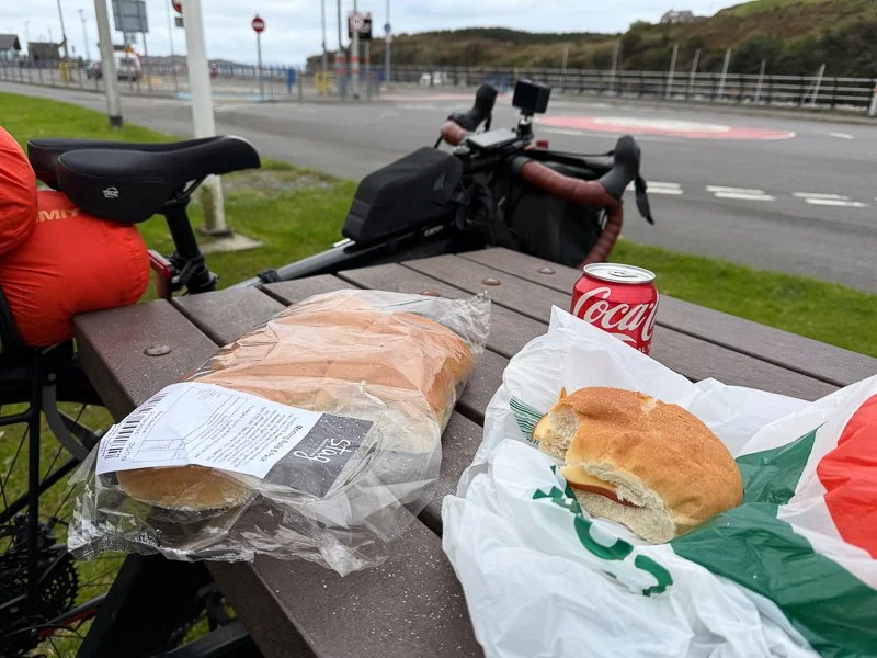 A bikepacker makes a sandwich on the Hebridean Way