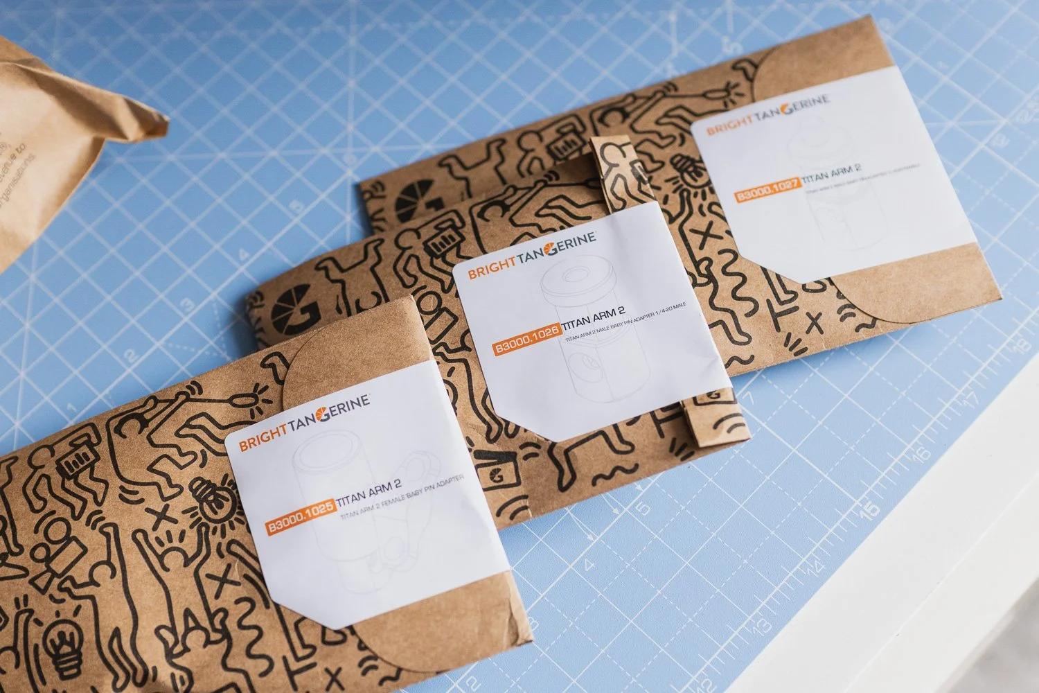 Bright Tangerine Titan Arm 2 Ti Packaging on blue background