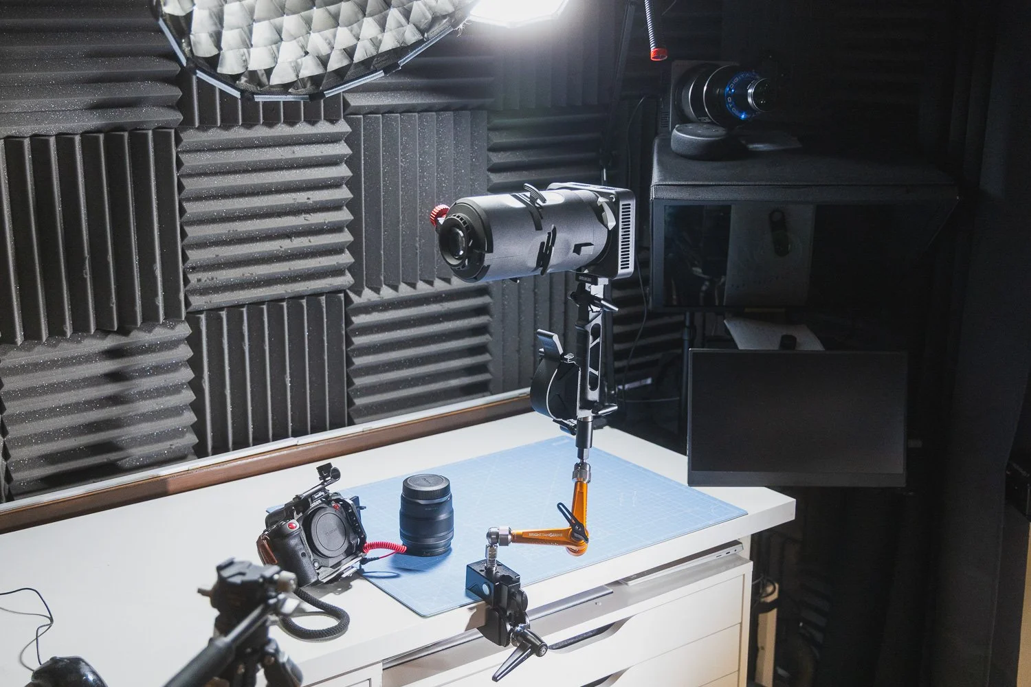 Bright Tangerine Titan Arm 2 Ti holding an Amaran Ray 120C with Spotlight SSE attachment