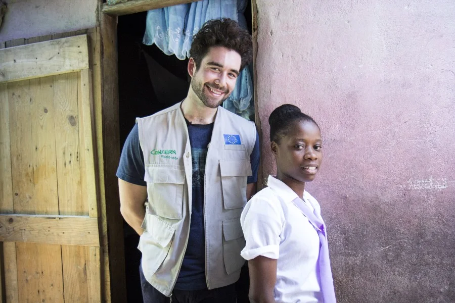 Gabe and Nerline in front of her house; Photo by Crystal Wells