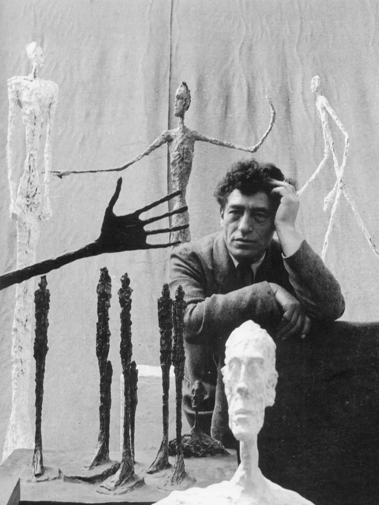 Alberto Giacometti with some of his sculptures