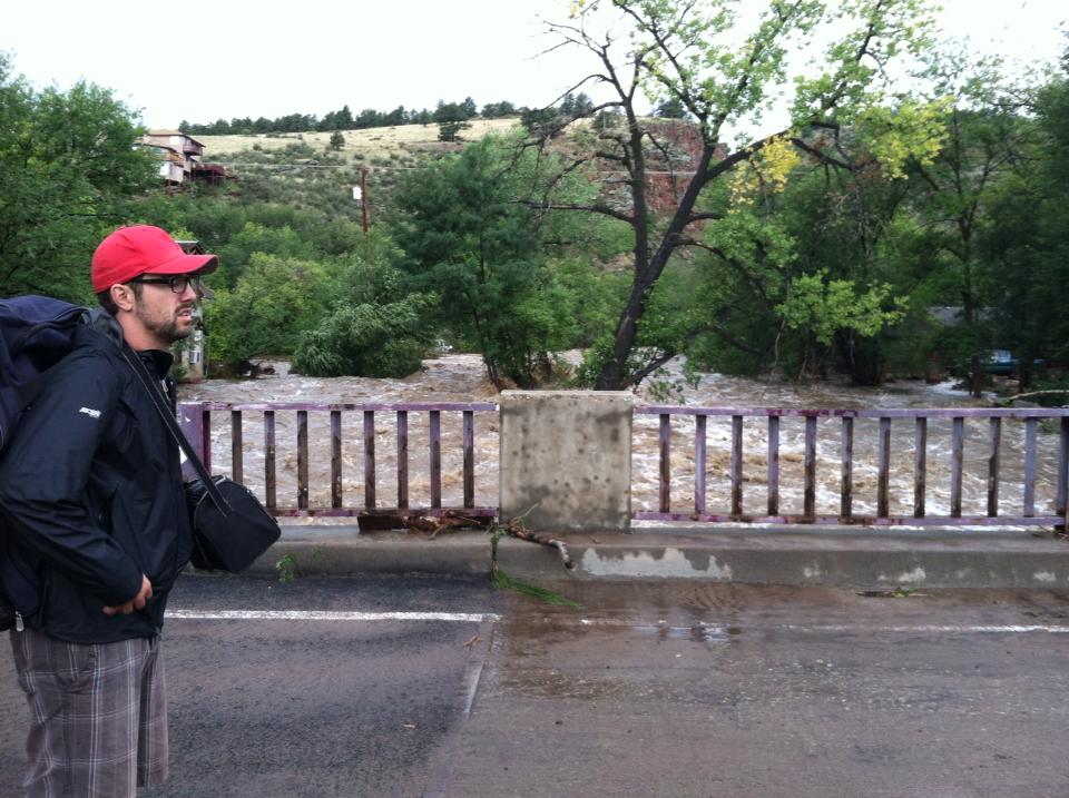 In front of the North St. Vrain River with frozen breast milk in tow in the soft side cooler. The river was 20 times the size it normally was.
