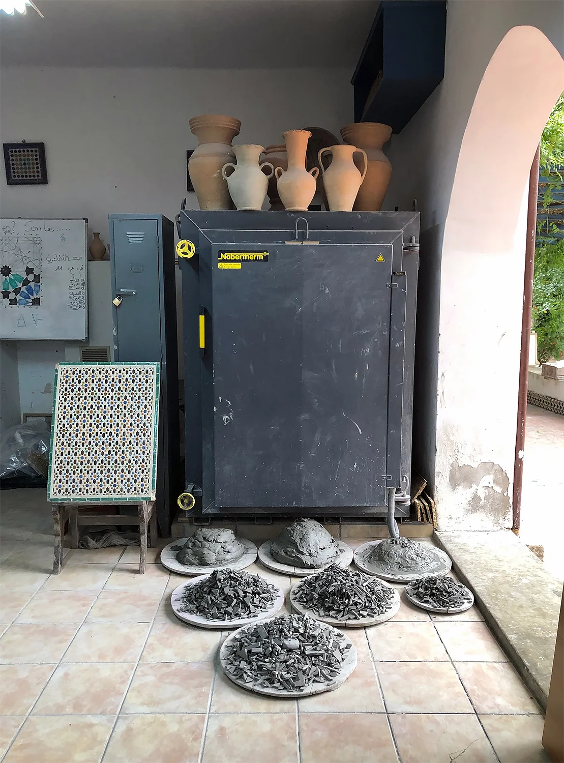 The beloved kiln with piles of clay scraps