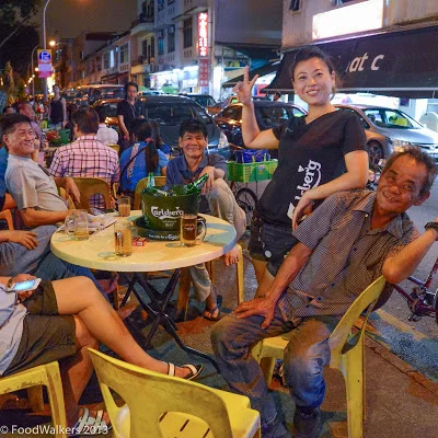 A beer girl and her boys in late night Geylang..