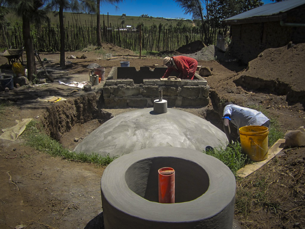 The fixed-dome biogas digester under construction