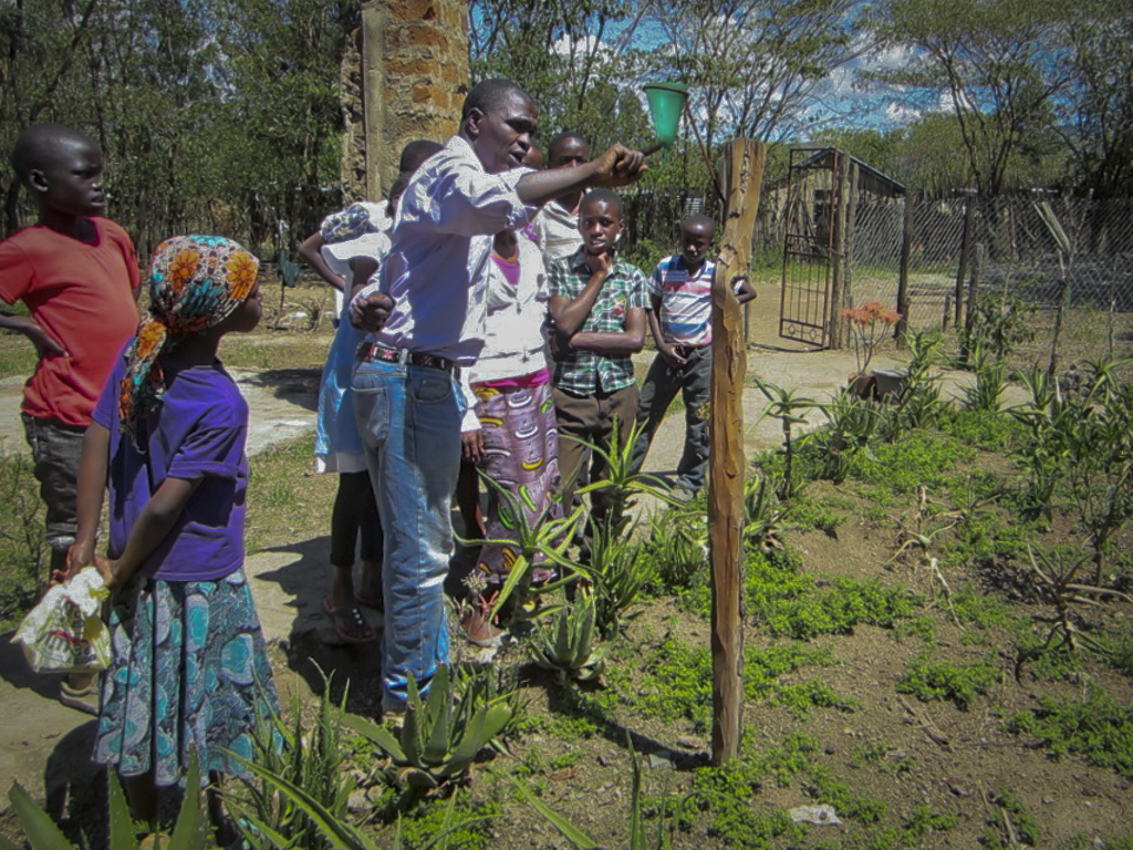 Students learn to read a rain gauge