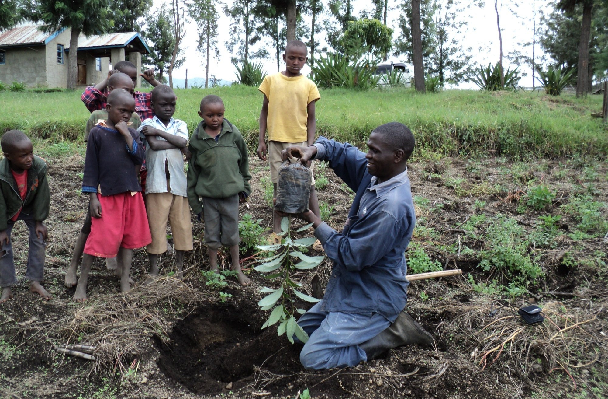 Josphat demonstrates tree planting technique