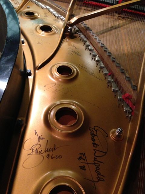 Michael Allen Harrison’s personal piano, a majestic Steinway and Sons D, loverly adorned with the signatures of other pianists who have performed on the instrument.