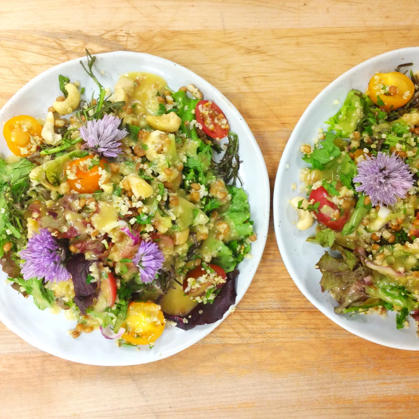 Spicy greens grain salad with chive blossoms