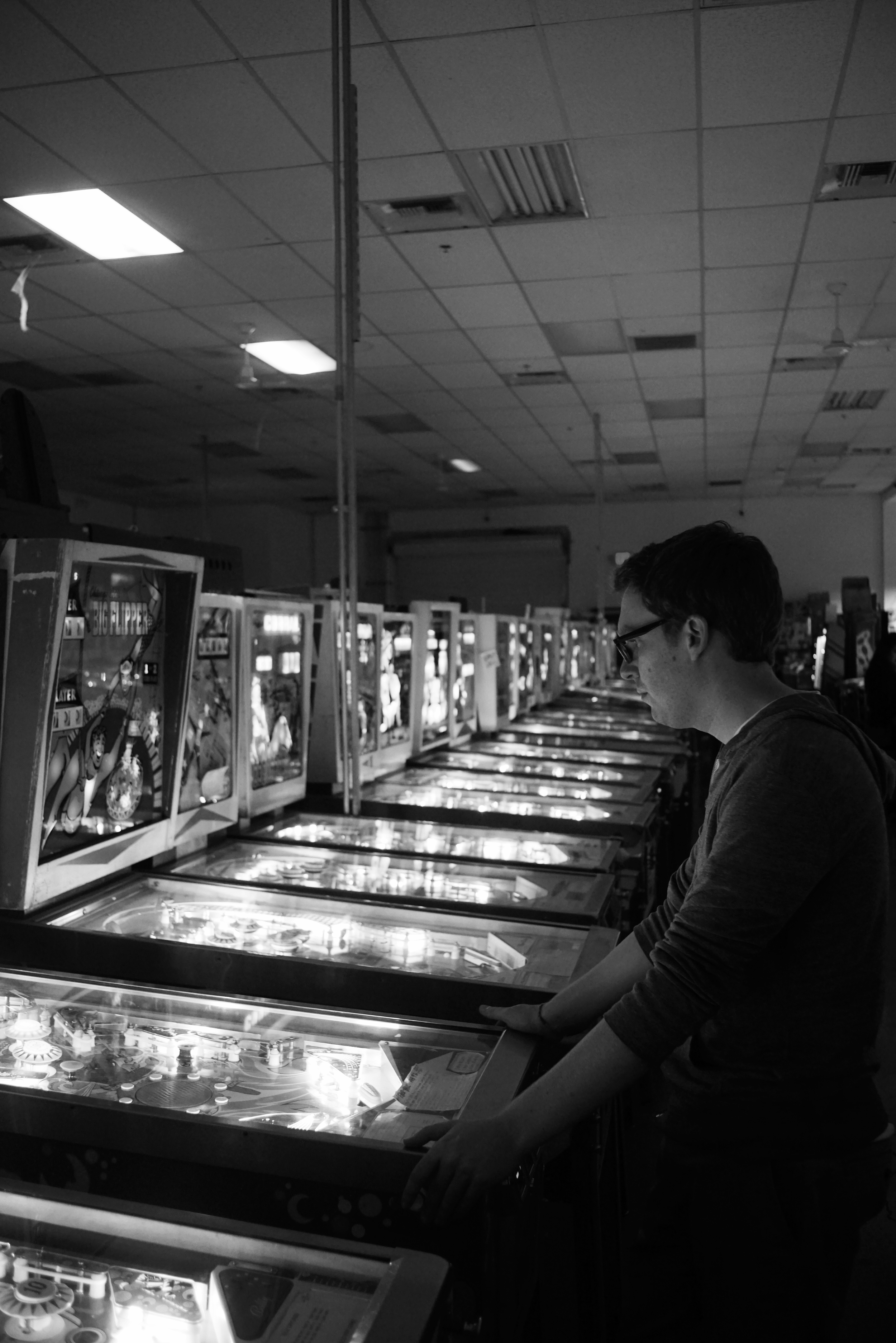 Both tourists and locals alike try their hand at winning a replay and beating high scores. Photo: Trey Takahashi