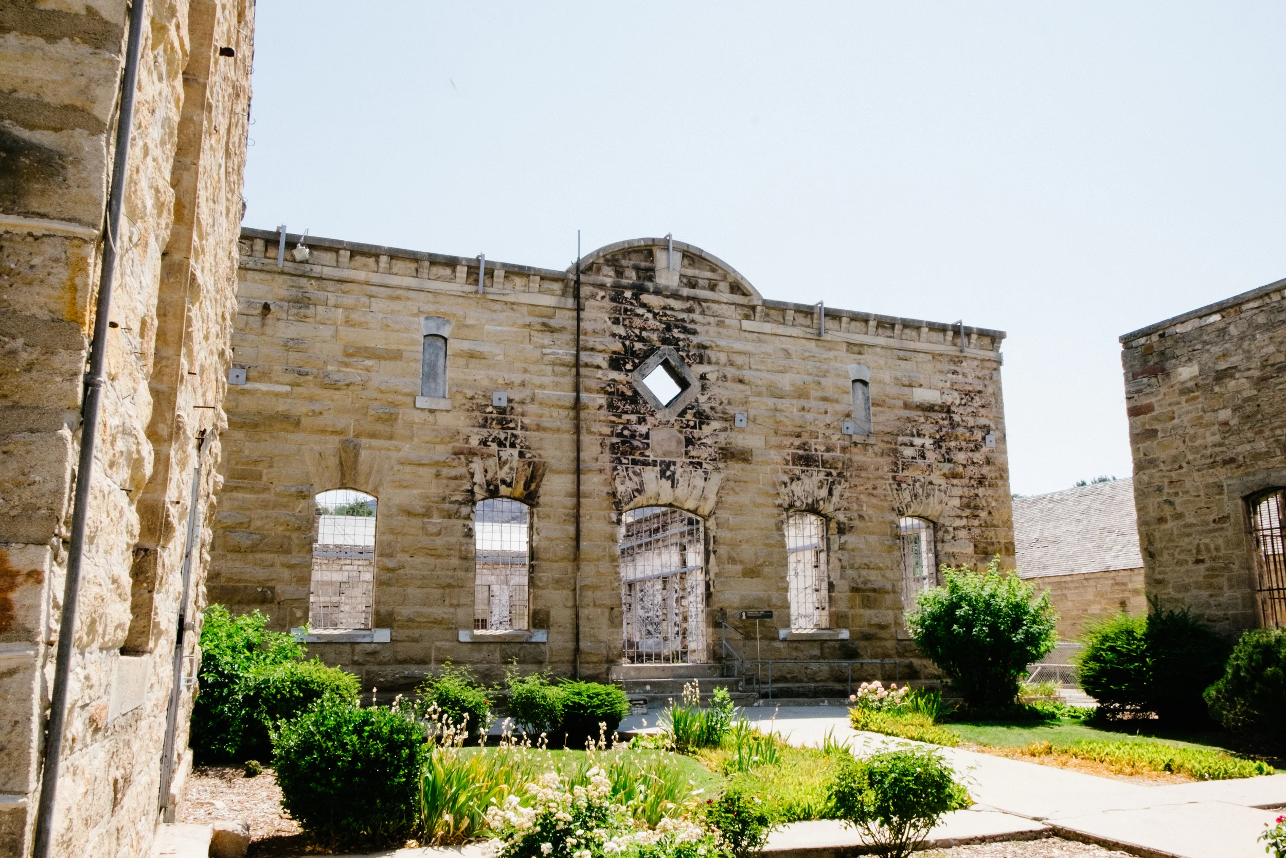 The walls of the mess hall and chapel still stand, with the charred marks of the fire visible.