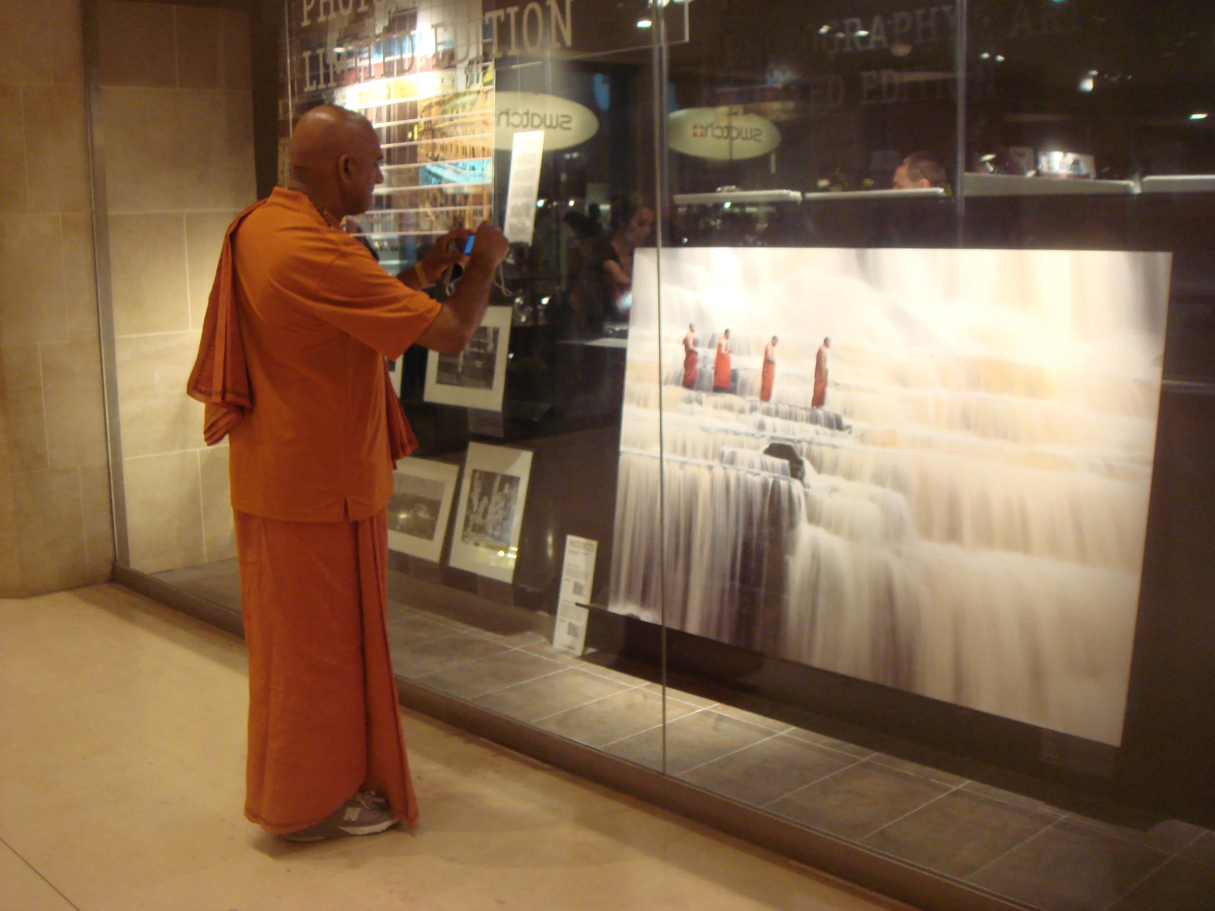 A living, breathing Buddhist monk encounters a large-scale photograph of Buddhist monks crossing a stream. Real and still. Makes me think of Verse 15 from the Tao te Ching: The ancient Masters were profound and subtle. Their wisdom was unfathomable. There is no way to describe it; all we can describe is their appearance. They were careful as someone crossing an iced-over stream. Alert as a warrior in enemy territory. Courteous as a guest. Fluid as melting ice. Shapable as a block of wood. Receptive as a valley. Clear as a glass of water. Do you have the patience to wait till your mud settles and the water is clear? Can you remain unmoving till the right action arises by itself? The Master doesn't seek fulfillment. Not seeking, not expecting, she is present, and can welcome all things. Stephen Mitchell translation
