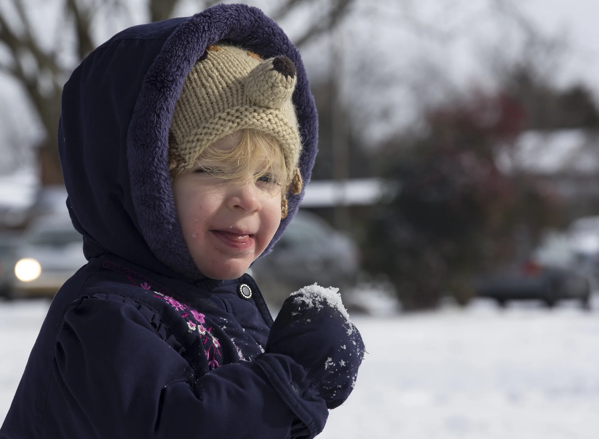 It’s the first snow that 2 and a half-year-old Del McGee can say the word snow. On Wednesday, January 29, 2014, Del and her mom Cordon Folds McGee take a trip to Weaver Street Market in Carrboro, N.C. to play. “She’s going to freeze her mouth in all this snow,” says McGee. “And that’s her hedgehog hat. Her favorite animal in the whole world.”