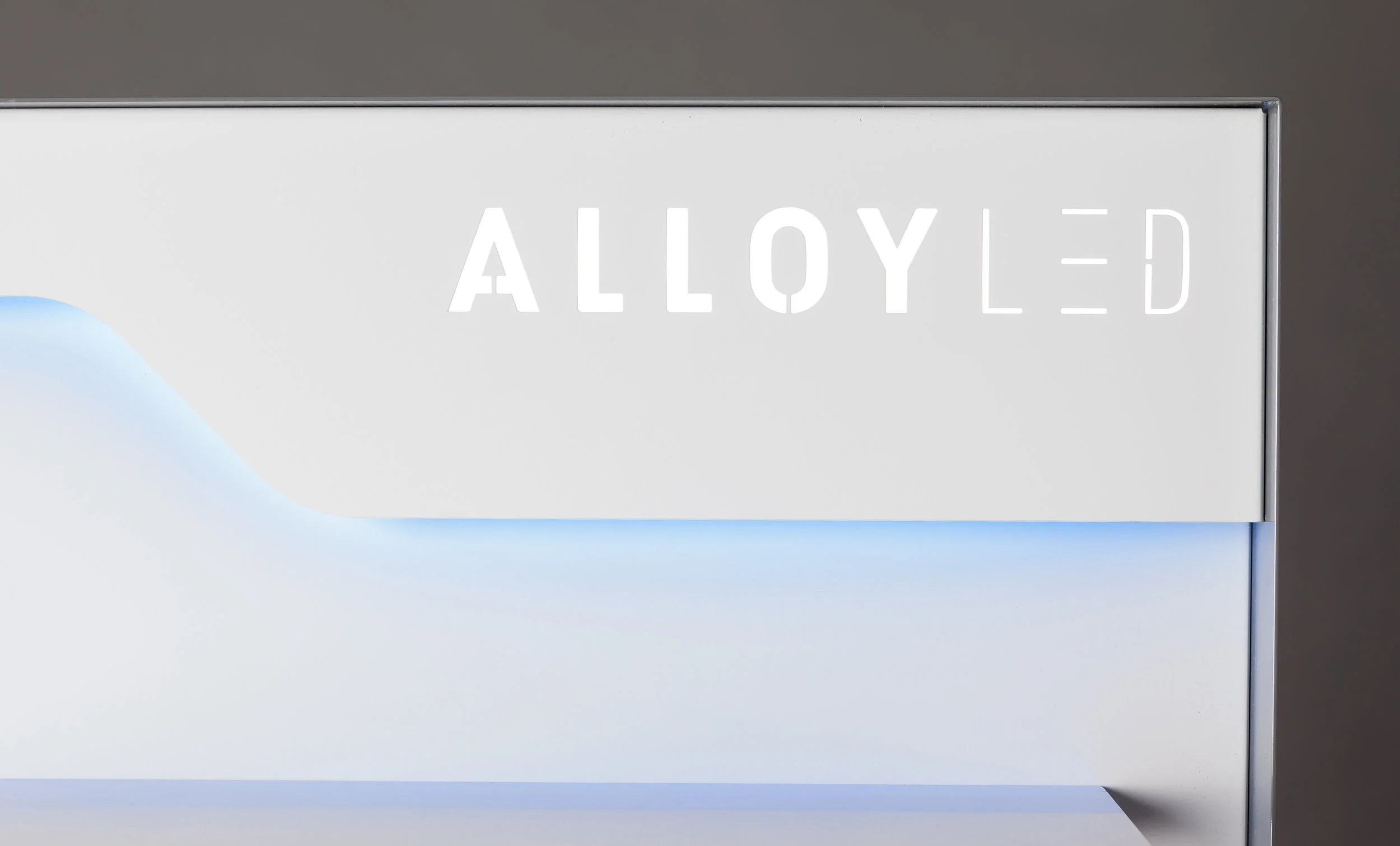 Back-lit white logo isolated from RGBW color accent