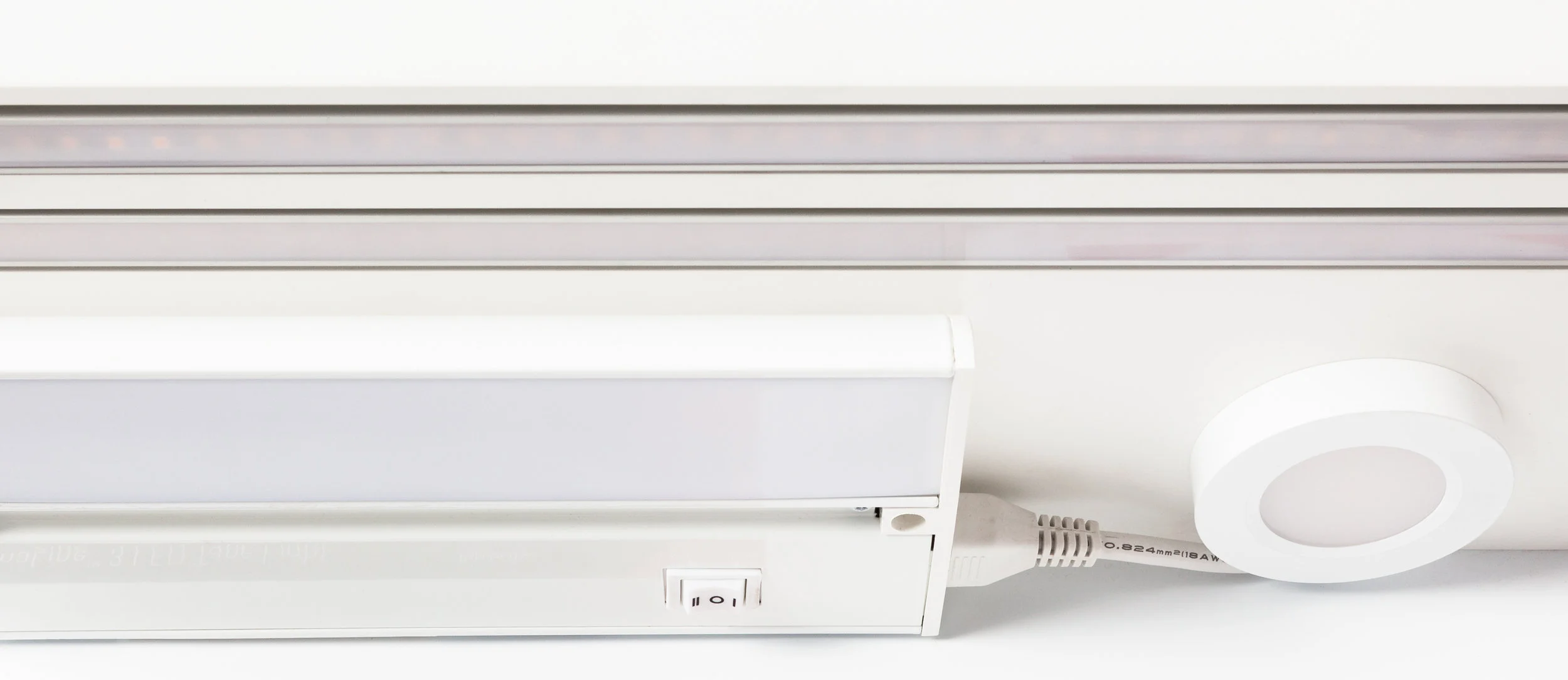 A selection of shelf mounted lights show the quality of the light projected onto a counter surface, at the standard cabinet height.