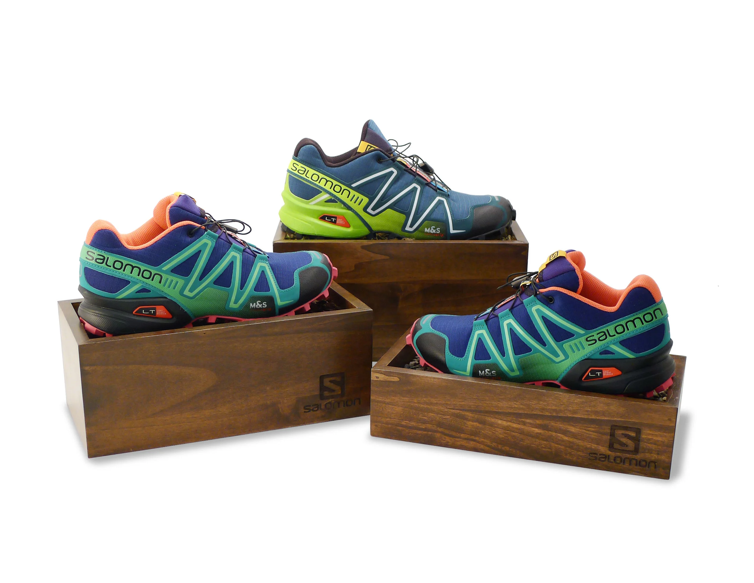 Salomon Trail Shoe Risers, featuring natural elements: rocks, moss, simulated wood chips 